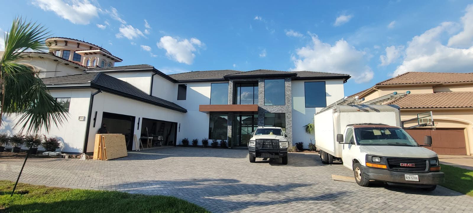 Modern two-story home with work vehicles in the driveway